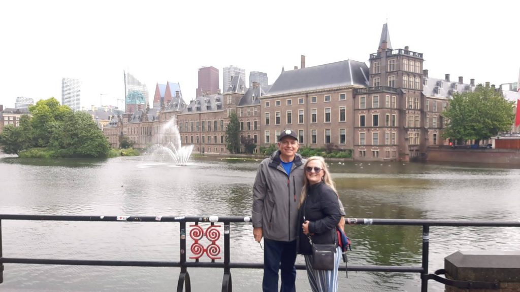 A man and a woman stand in front of a castle in the Hague