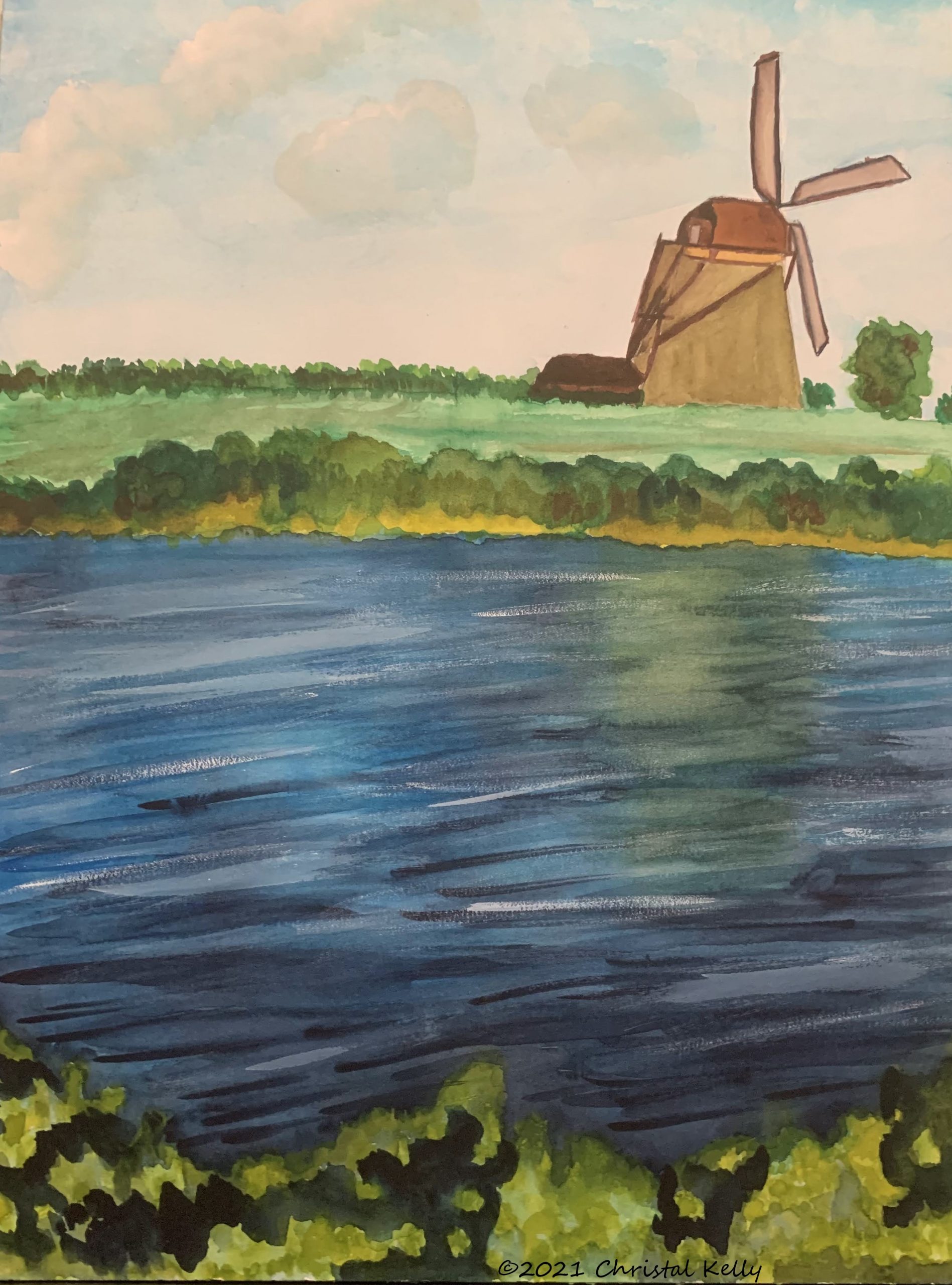 windmill by flowing water